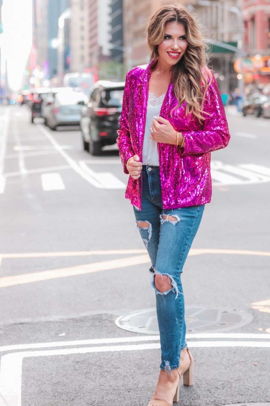 a full sequin-covered long-sleeve blazer with a structured collar, subtle shoulder pads, a smooth interior lining, and a center back vent in pink