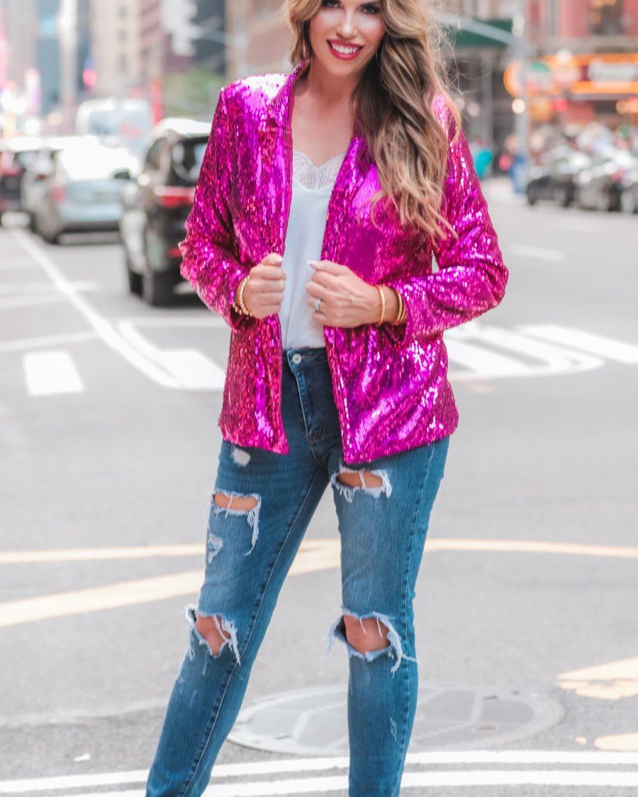 a full sequin-covered long-sleeve blazer with a structured collar, subtle shoulder pads, a smooth interior lining, and a center back vent in pink