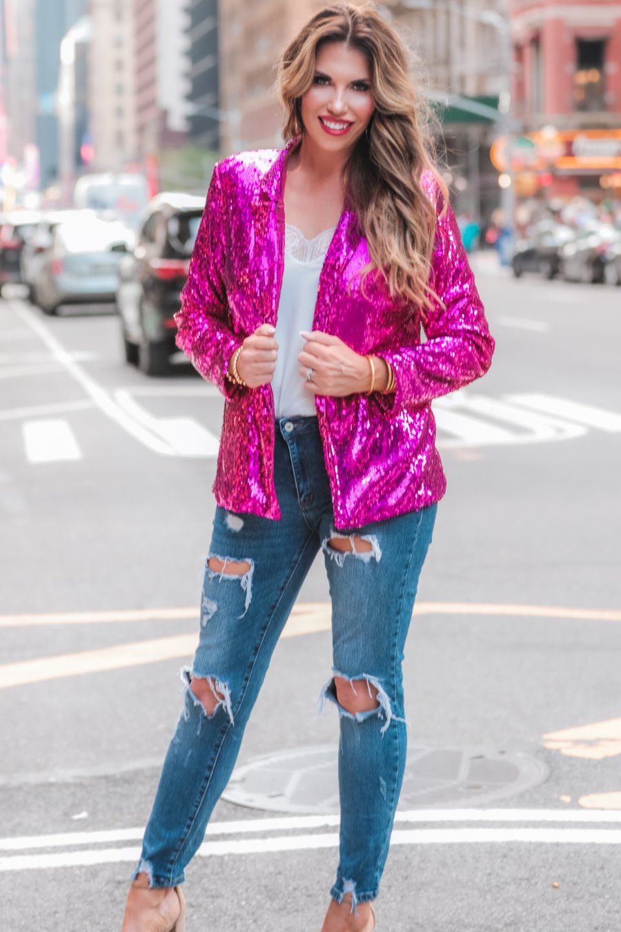 a full sequin-covered long-sleeve blazer with a structured collar, subtle shoulder pads, a smooth interior lining, and a center back vent in pink