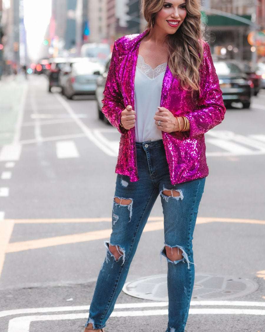 a full sequin-covered long-sleeve blazer with a structured collar, subtle shoulder pads, a smooth interior lining, and a center back vent in pink