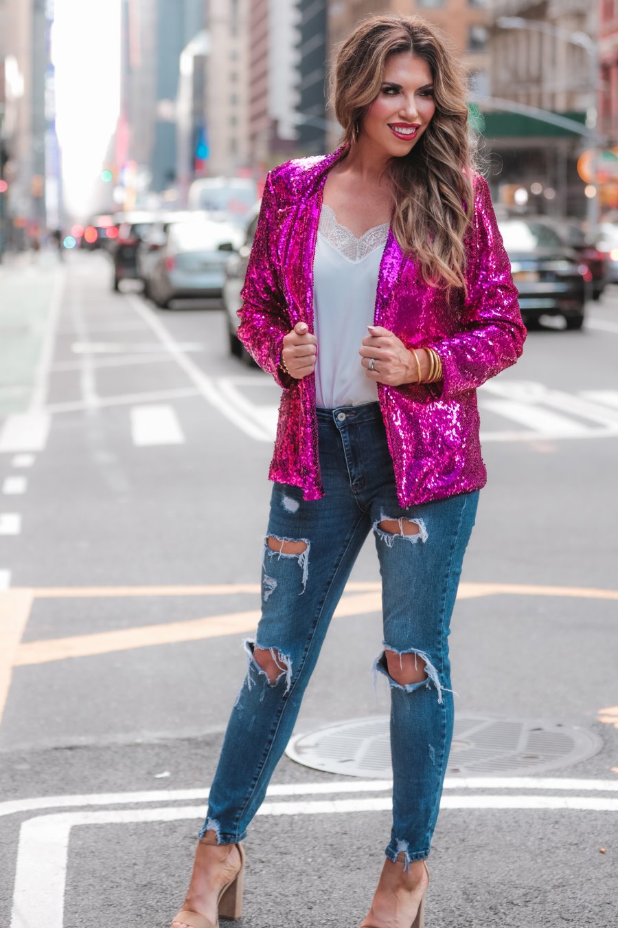 a full sequin-covered long-sleeve blazer with a structured collar, subtle shoulder pads, a smooth interior lining, and a center back vent in pink