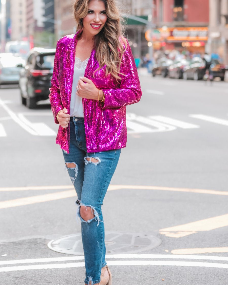 a full sequin-covered long-sleeve blazer with a structured collar, subtle shoulder pads, a smooth interior lining, and a center back vent in pink