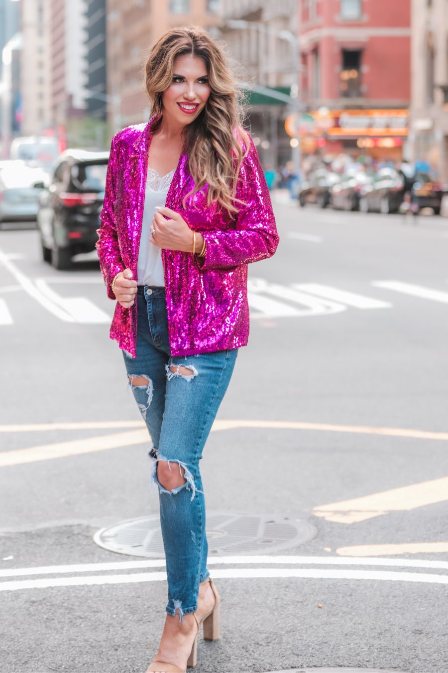 a full sequin-covered long-sleeve blazer with a structured collar, subtle shoulder pads, a smooth interior lining, and a center back vent in pink