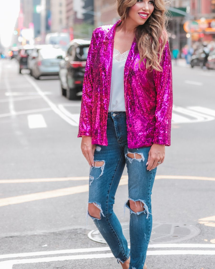 a full sequin-covered long-sleeve blazer with a structured collar, subtle shoulder pads, a smooth interior lining, and a center back vent in pink