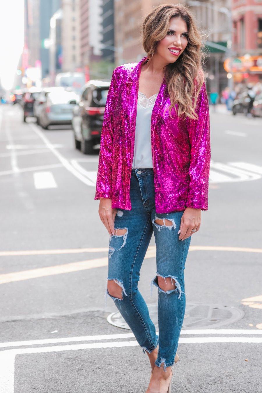 a full sequin-covered long-sleeve blazer with a structured collar, subtle shoulder pads, a smooth interior lining, and a center back vent in pink