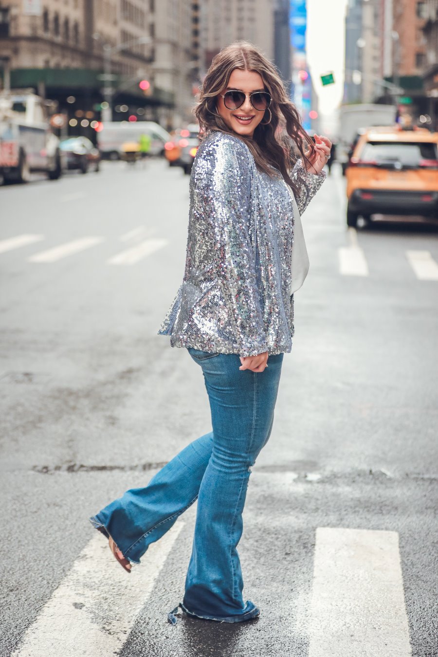 a full sequin-covered long-sleeve blazer with a structured collar, subtle shoulder pads, a smooth interior lining, and a center back vent in silver