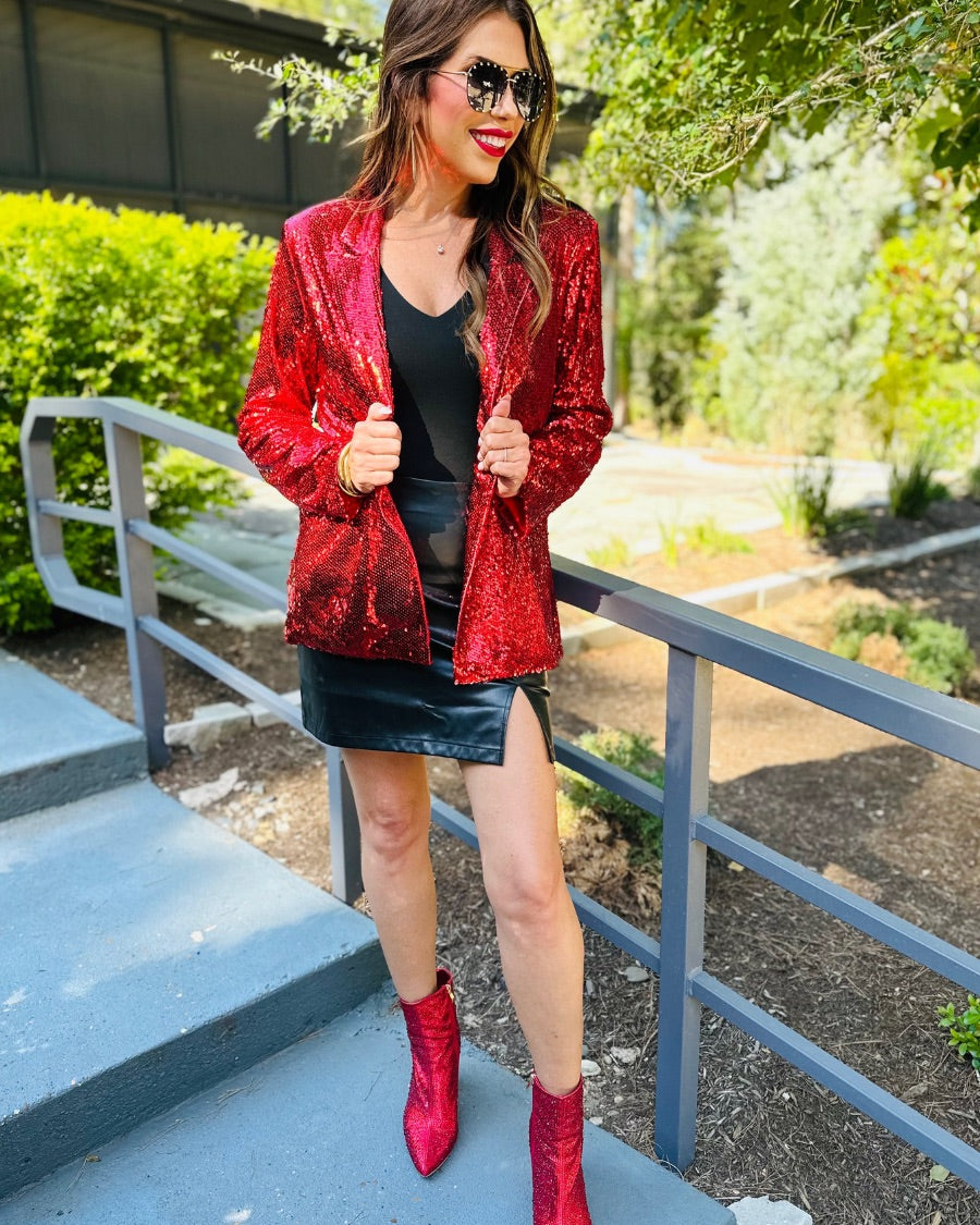 a full sequin-covered long-sleeve blazer with a structured collar, subtle shoulder pads, a smooth interior lining, and a center back vent in red