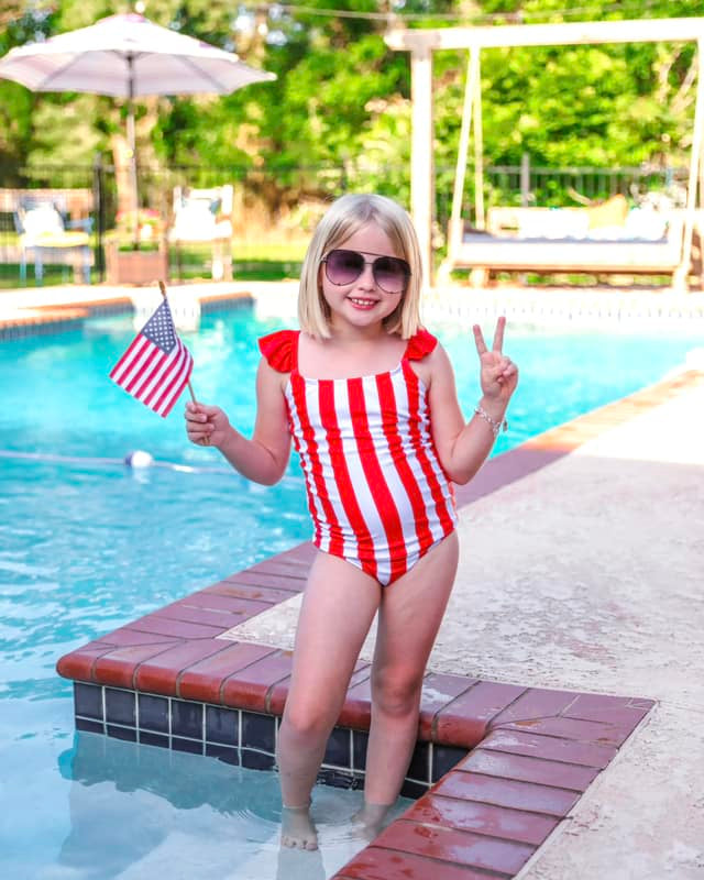 red and white vertical stripe one-piece swimsuit with ruffle sleeves and a criss-cross back