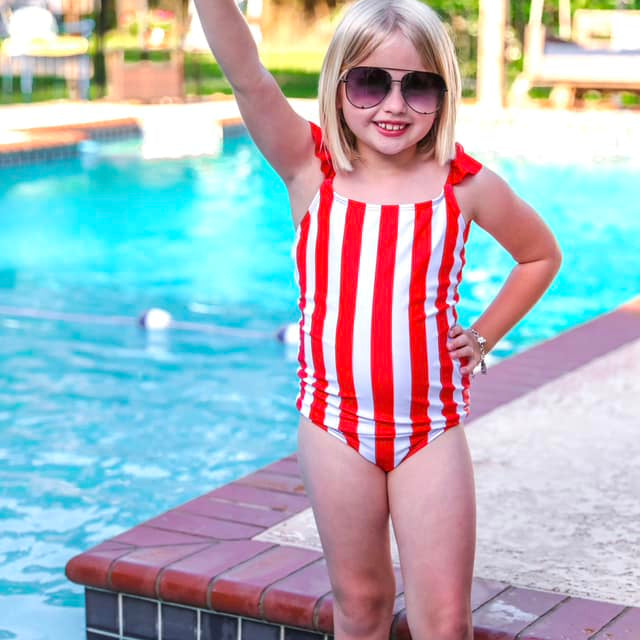 red and white vertical stripe one-piece swimsuit with ruffle sleeves and a criss-cross back