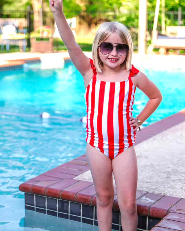 red and white vertical stripe one-piece swimsuit with ruffle sleeves and a criss-cross back