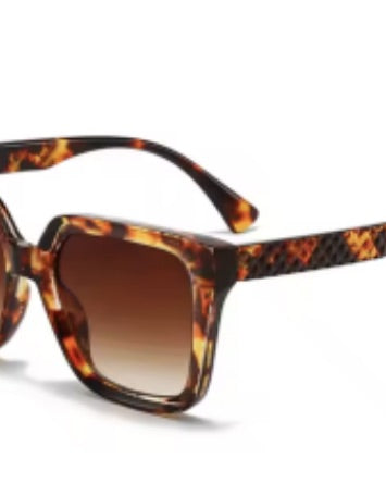 oversized square sunglasses in tortoise with dark lenses, a raised geometric texture on the temples, and brand name detail (on both the temple and the complimentary black pouch)
