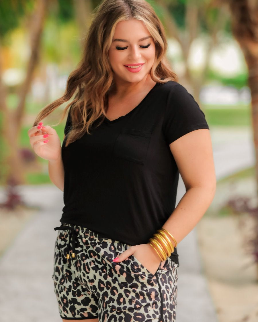 mid-rise relaxed fit activewear shorts with side pockets and a tie waist drawstring with gold bead accents, designed on a black and brown leopard pattern print fabric, tan base, and black trim