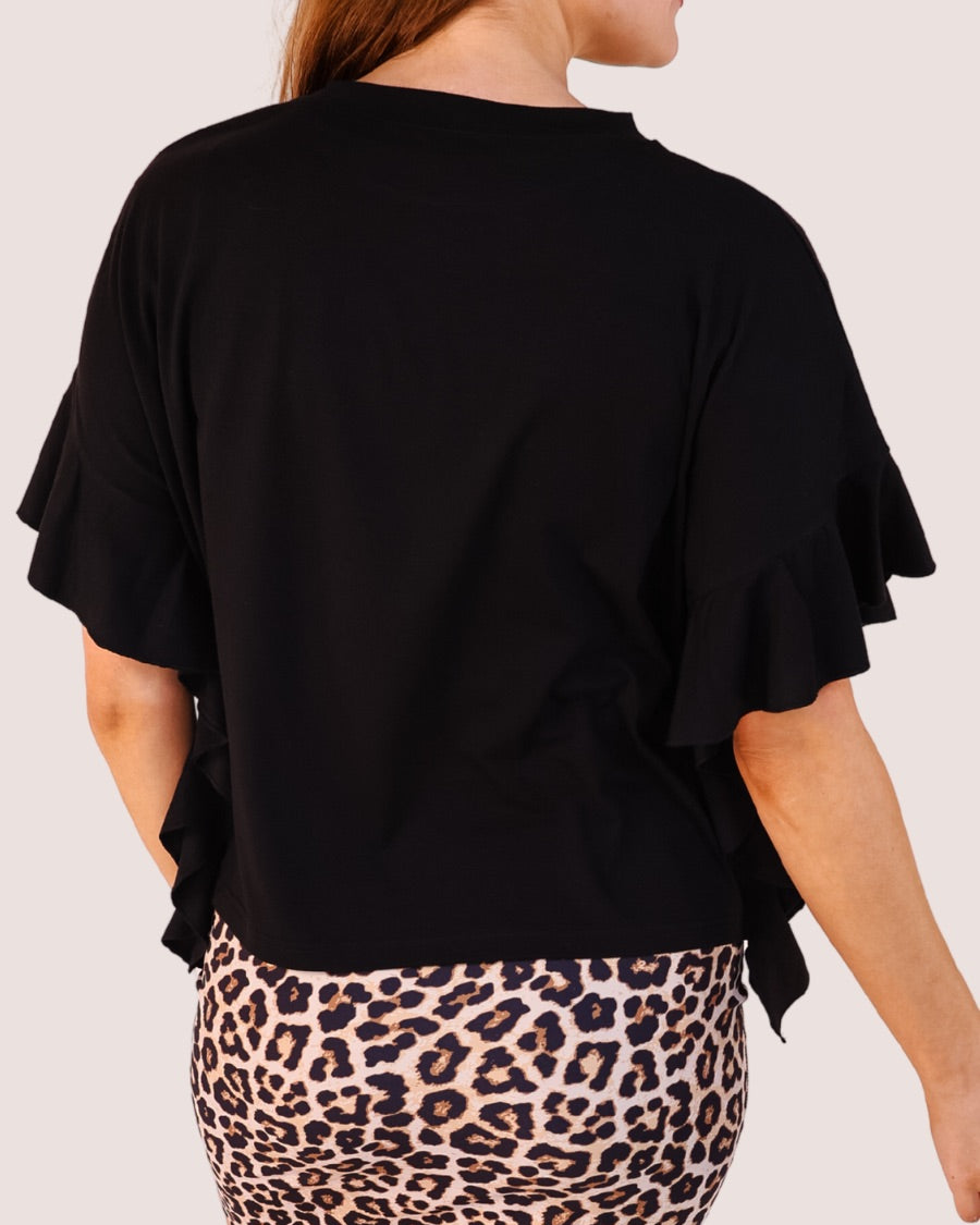 fluttery ruffle short-sleeve top with a mom crop length, sewn-on chenille football bow patches outlined in sequins on a soft, stretch-knit fabric in black