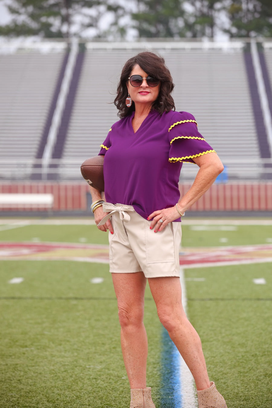 a playful V-neckline top with a ric rac trim detailing on the layered ruffled short sleeves