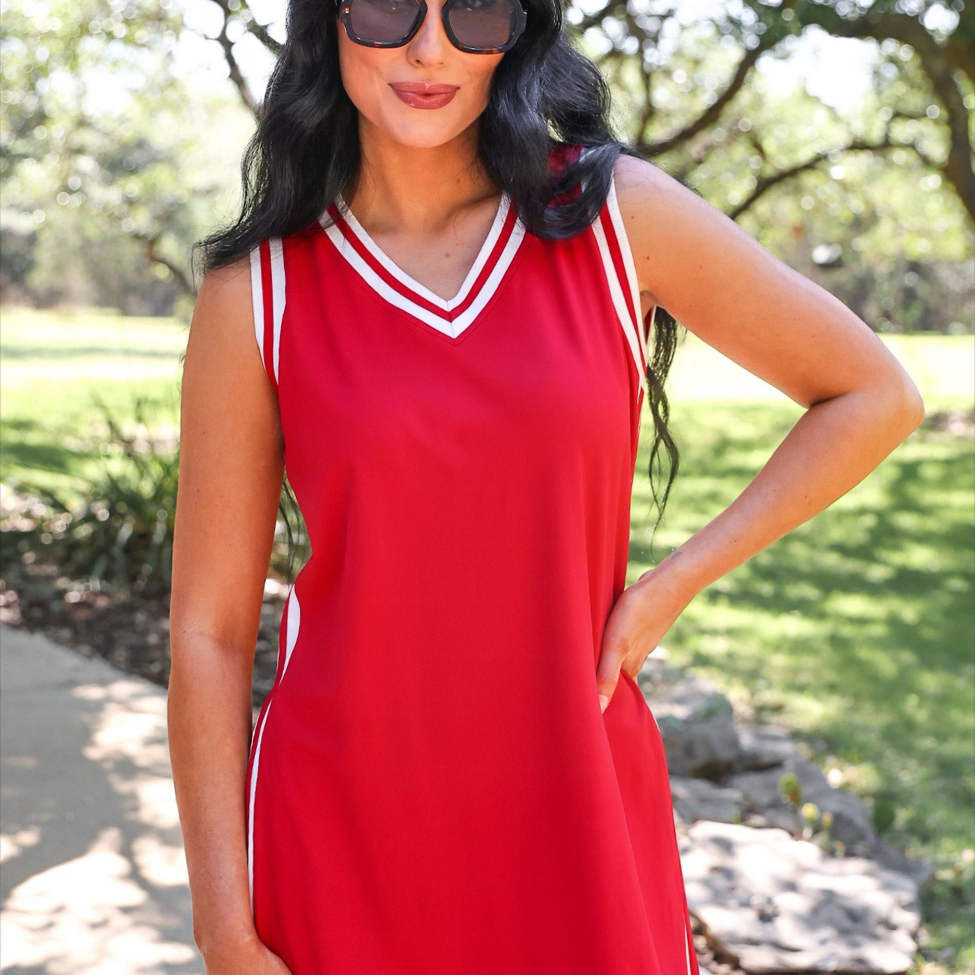 a red two-piece sleeveless tunic and biker short set with varsity stripe trim, V-neckline, side slits, side pockets, soft stretch fabric, and pre-washed finish