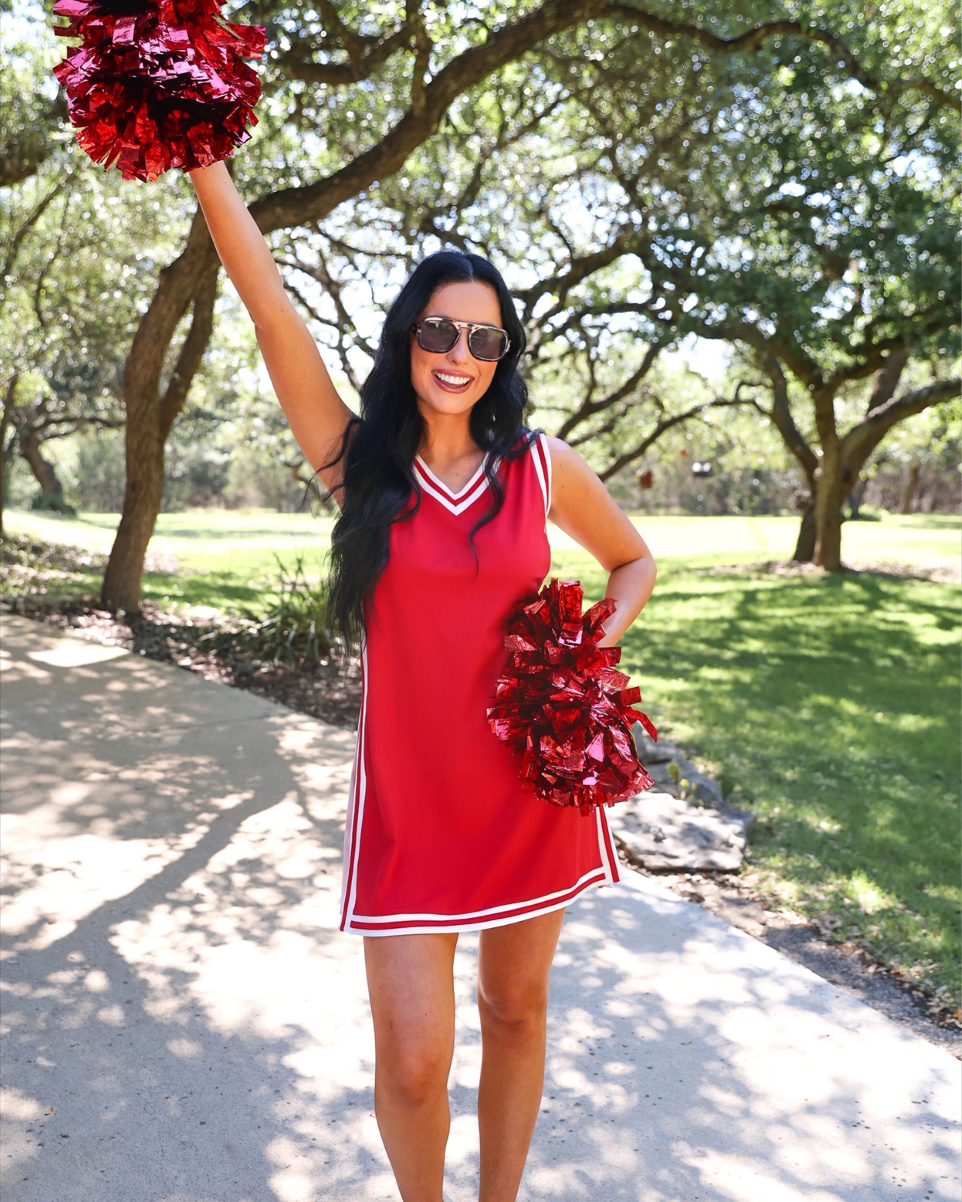 a red two-piece sleeveless tunic and biker short set with varsity stripe trim, V-neckline, side slits, side pockets, soft stretch fabric, and pre-washed finish