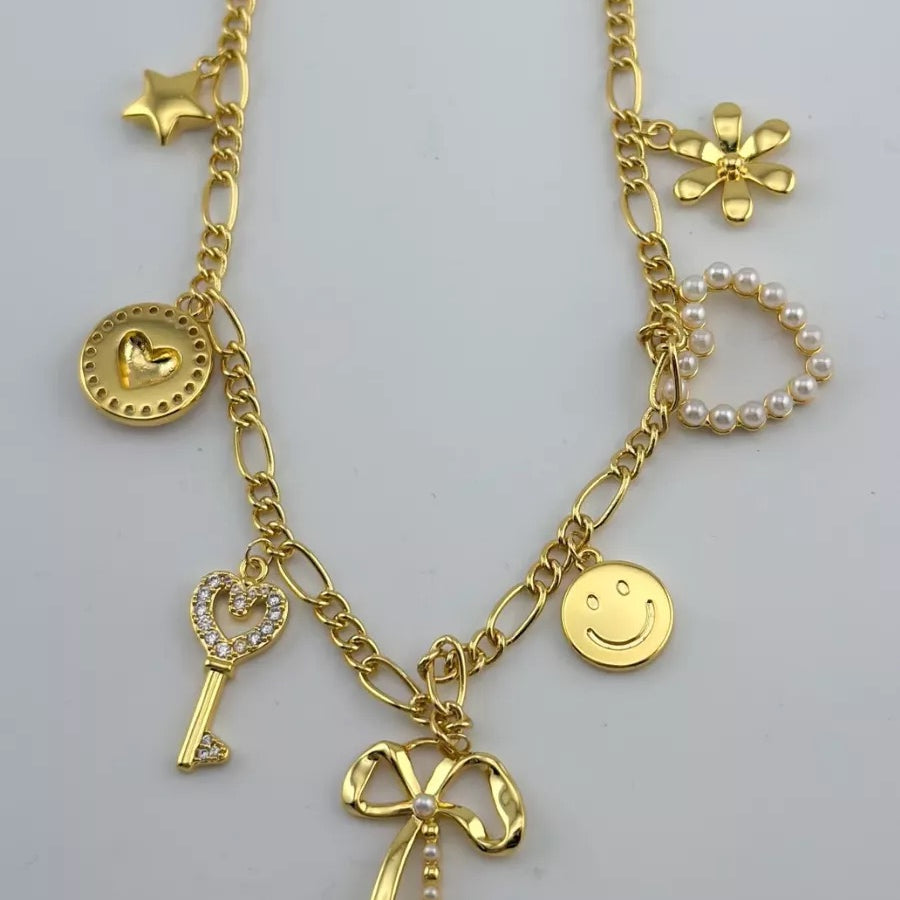 a gold-plated necklace with a stylish chain and seven charms adorned in pearls and rhinestones