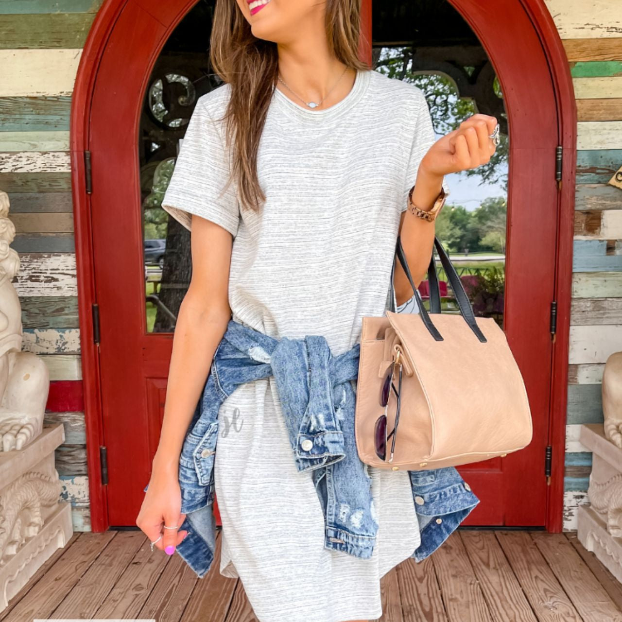 rolled-sleeve dress with a round neckline, hip pockets, and a curved hemline behind a MADE IN USA watermark in the bottom left-hand corner