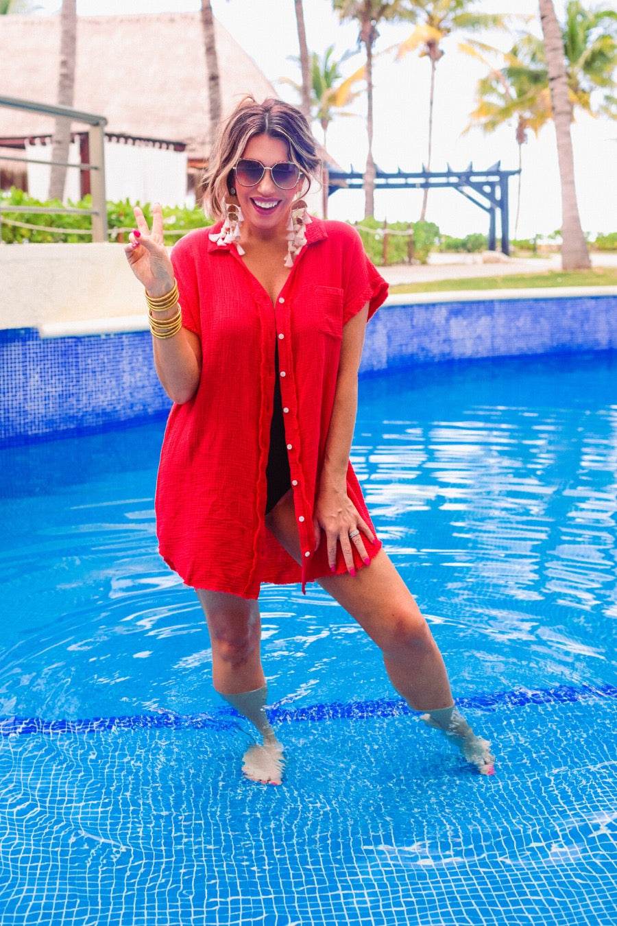 lightweight, non-stretchy gauze button-up coverup with a raw hem, chest pocket, and collar in red