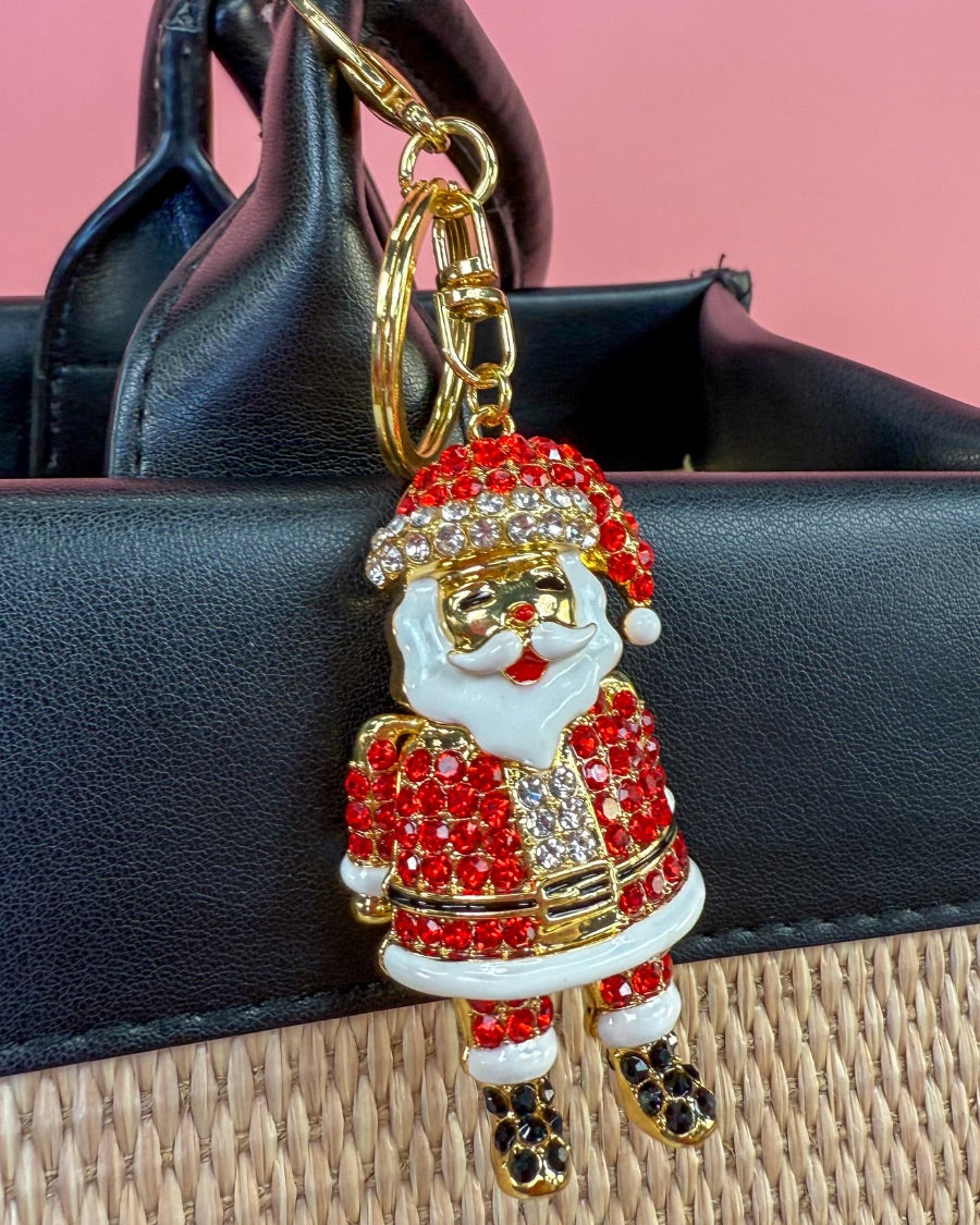 a gleaming Santa bag charm with sparkling rhinestones, movable arms, a solid heavyweight feel, a gold-tone swivel clasp with matching keyring, and a fully gold openwork back for added dimension