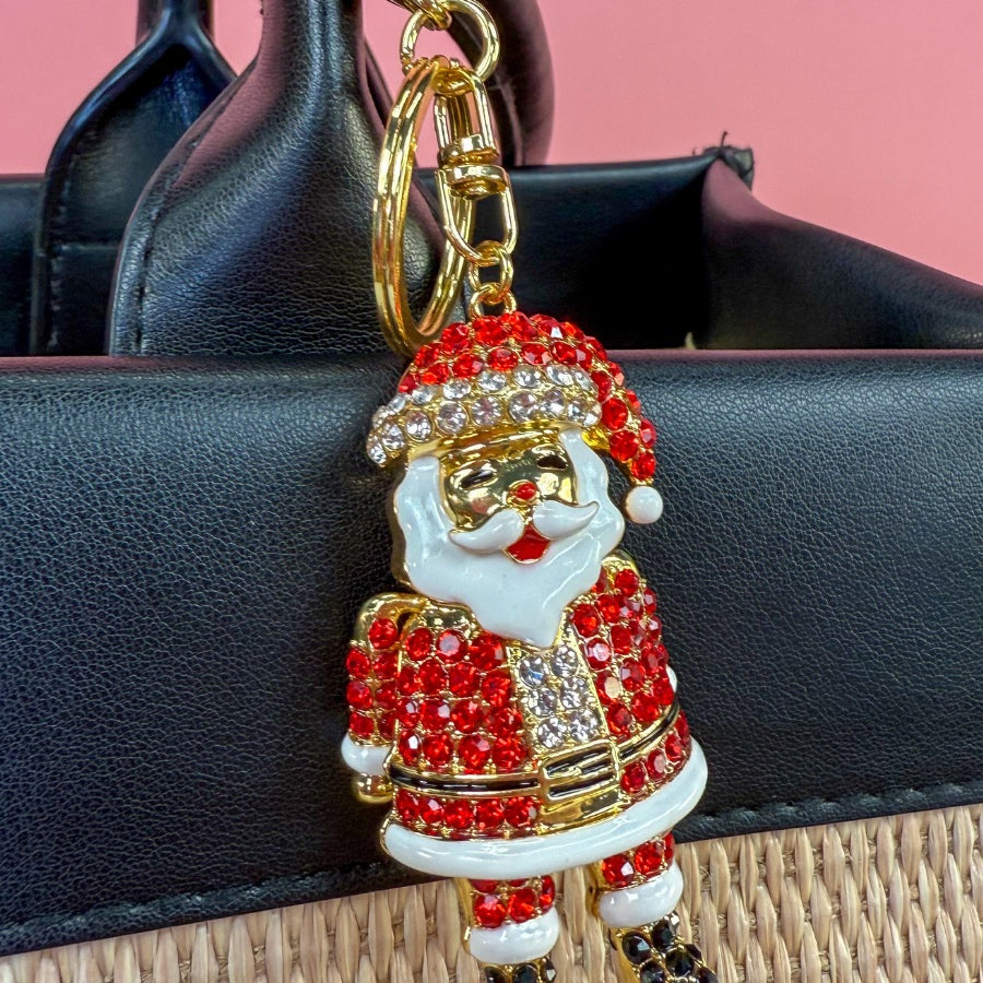 a gleaming Santa bag charm with sparkling rhinestones, movable arms, a solid heavyweight feel, a gold-tone swivel clasp with matching keyring, and a fully gold openwork back for added dimension