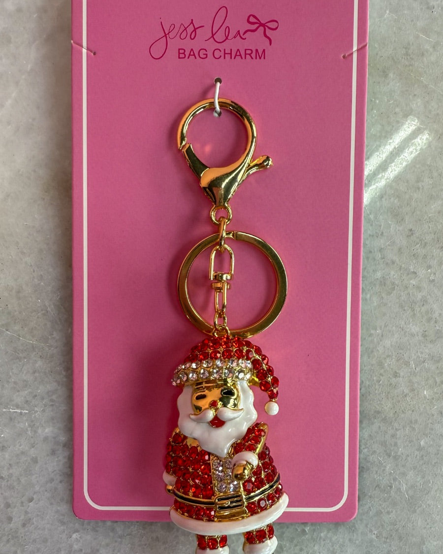 a gleaming Santa bag charm with sparkling rhinestones, movable arms, a solid heavyweight feel, a gold-tone swivel clasp with matching keyring, and a fully gold openwork back for added dimension