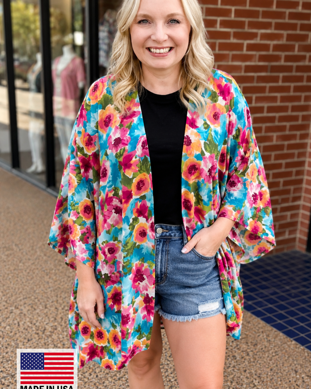 an exclusive, vibrant multicolor floral open-front kimono crafted from limited boutique fabric with lightweight woven material and a fluid, elongated drape, finished with a MADE IN USA watermark in the bottom left-hand corner