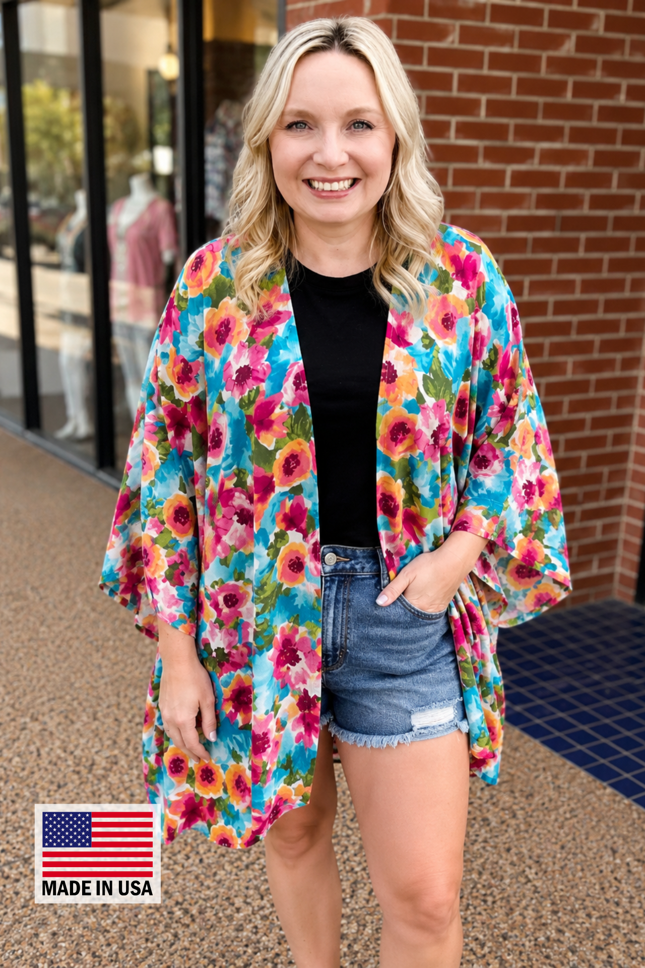 an exclusive, vibrant multicolor floral open-front kimono crafted from limited boutique fabric with lightweight woven material and a fluid, elongated drape, finished with a MADE IN USA watermark in the bottom left-hand corner