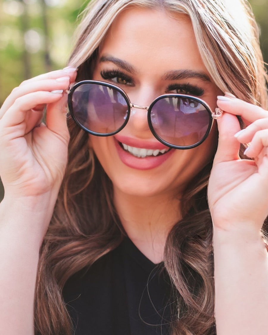 round sunglasses with black and gold wireframes, matching sides, tinted lenses, UV protection, and brand name detail (on both the temple and the complimentary black pouch)