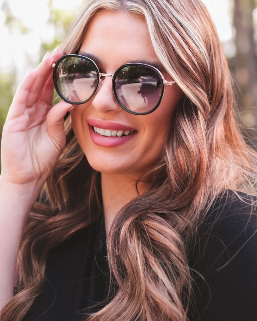 round sunglasses with black and gold wireframes, matching sides, tinted lenses, UV protection, and brand name detail (on both the temple and the complimentary black pouch)