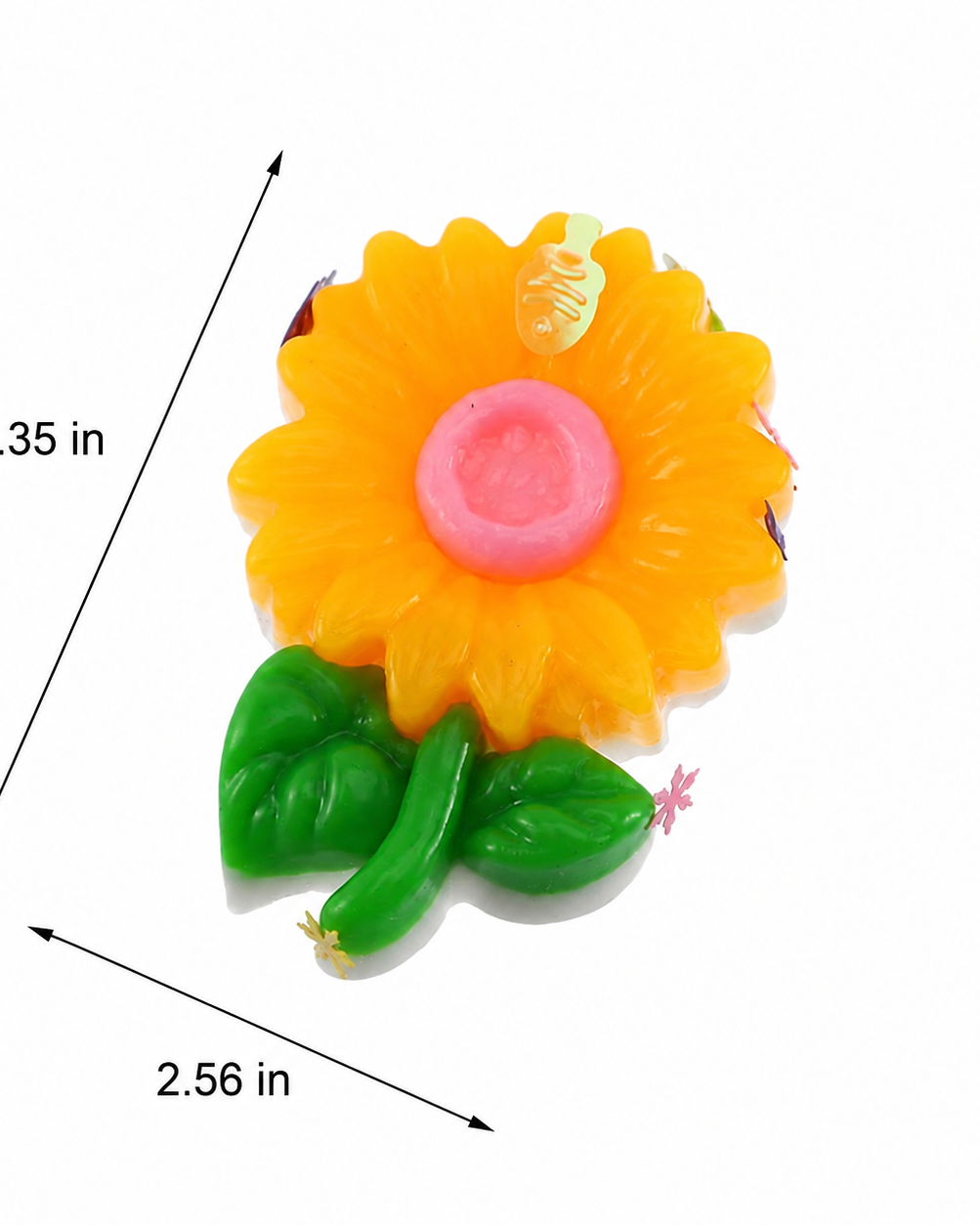 a yellow flower-shaped decompression squishy toy with glossy petals, green leaves, mini decorative accents, pastel pom poms, and size measurements