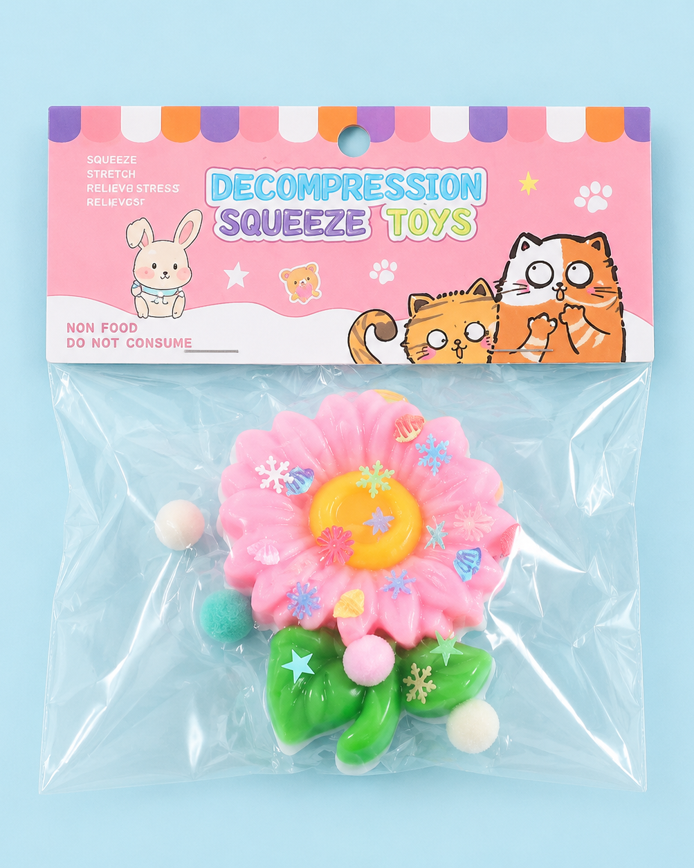 a pink flower-shaped decompression squishy toy with glossy petals, green leaves, mini decorative accents, and pastel pom poms