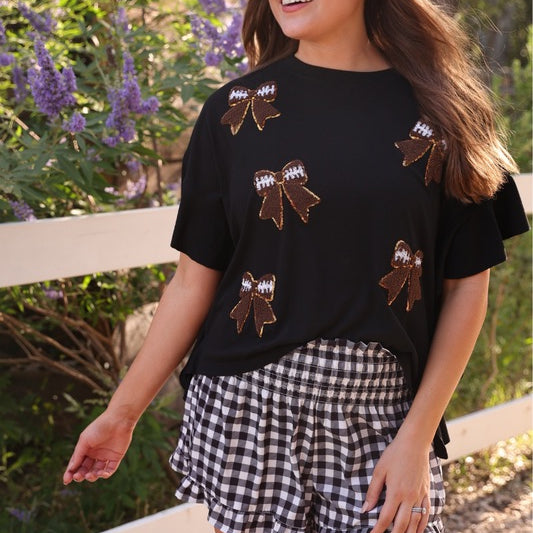 high-waisted gingham shorts with smocked waistband and ruffle hem in black