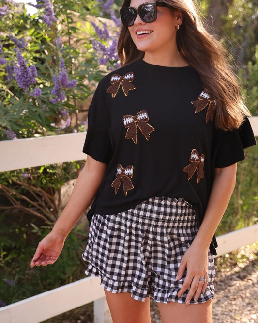 high-waisted gingham shorts with smocked waistband and ruffle hem in black
