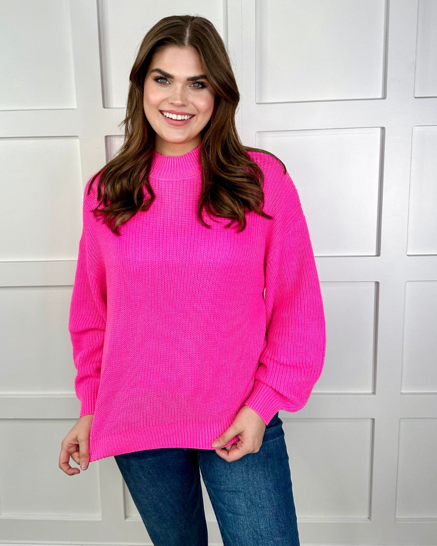 a pink long sleeve sweater with a drop-shoulder for a relaxed fit, a crew neckline, and a ribbed hemline on a textured ultra-soft design fabric