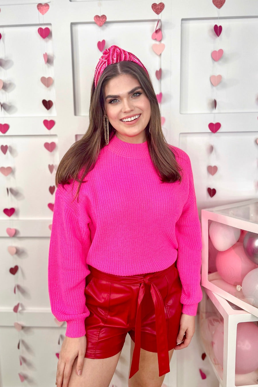 a pink long sleeve sweater with a drop-shoulder for a relaxed fit, a crew neckline, and a ribbed hemline on a textured ultra-soft design fabric