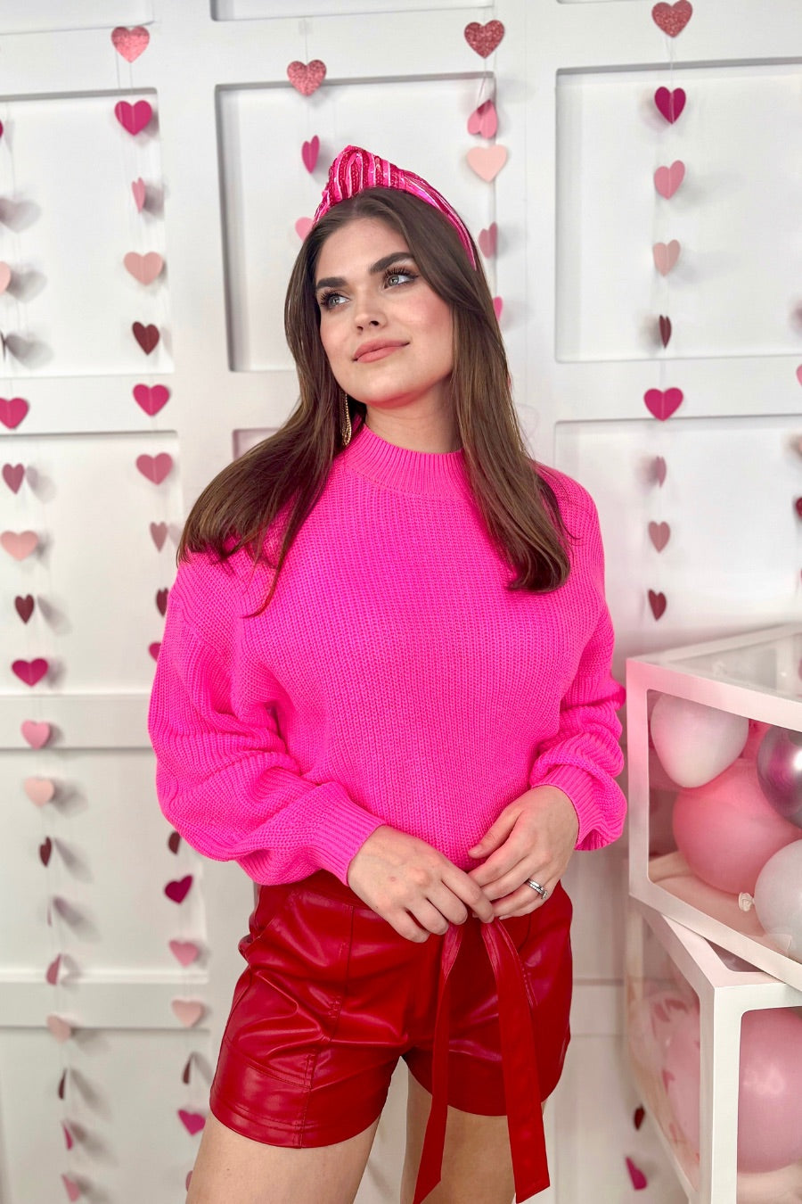 a pink long sleeve sweater with a drop-shoulder for a relaxed fit, a crew neckline, and a ribbed hemline on a textured ultra-soft design fabric