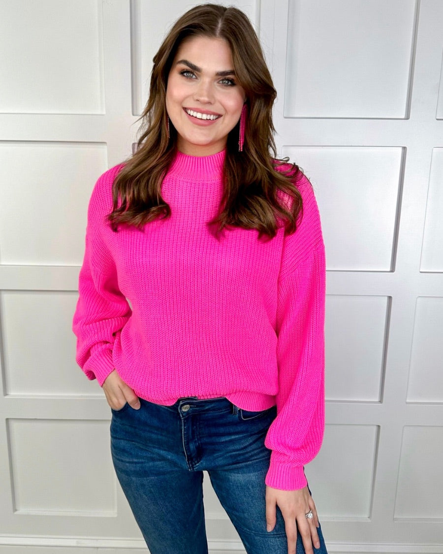 a pink long sleeve sweater with a drop-shoulder for a relaxed fit, a crew neckline, and a ribbed hemline on a textured ultra-soft design fabric