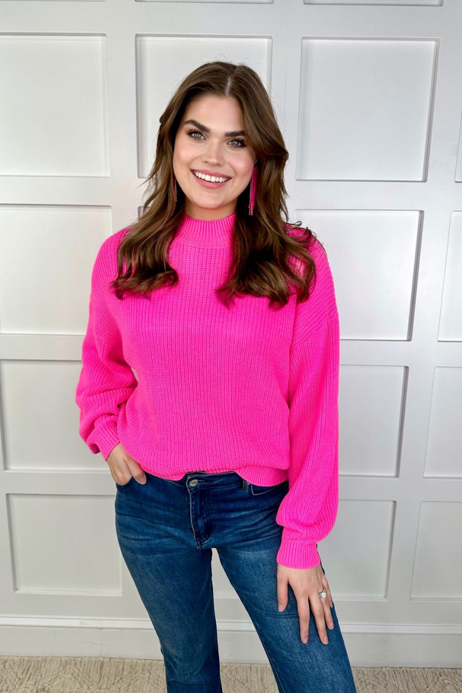 a pink long sleeve sweater with a drop-shoulder for a relaxed fit, a crew neckline, and a ribbed hemline on a textured ultra-soft design fabric