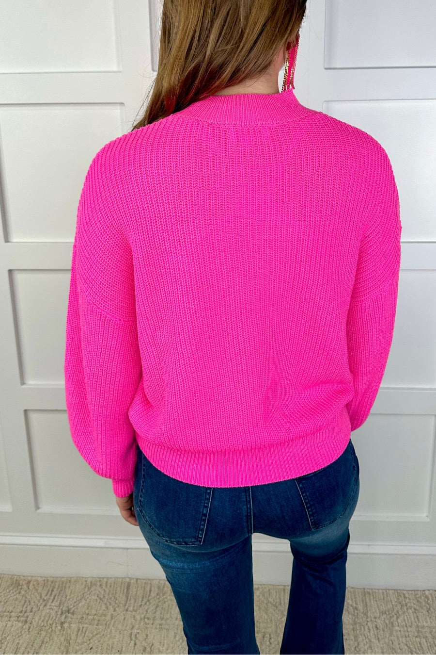 a pink long sleeve sweater with a drop-shoulder for a relaxed fit, a crew neckline, and a ribbed hemline on a textured ultra-soft design fabric