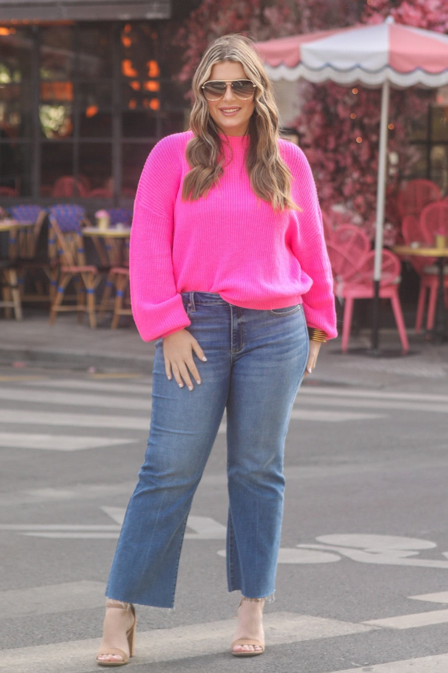 a pink long sleeve sweater with a drop-shoulder for a relaxed fit, a crew neckline, and a ribbed hemline on a textured ultra-soft design fabric