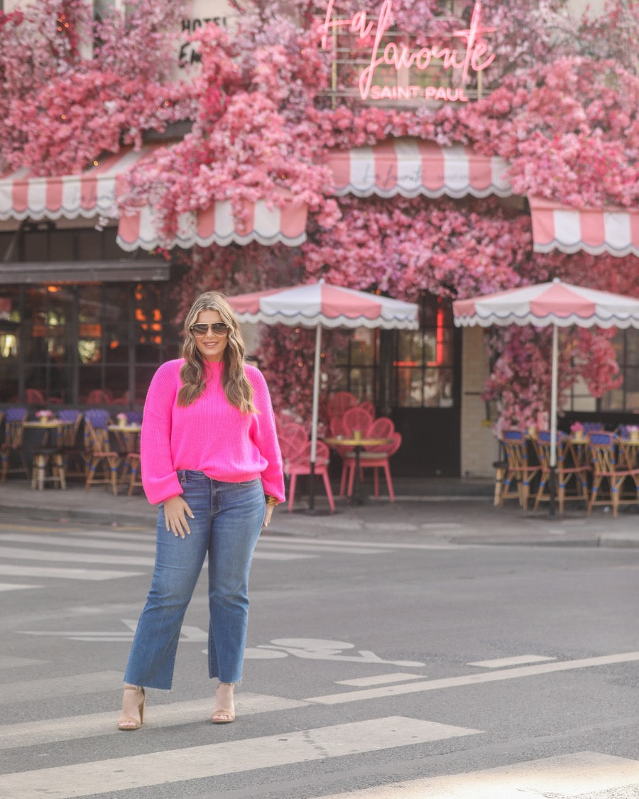 a pink long sleeve sweater with a drop-shoulder for a relaxed fit, a crew neckline, and a ribbed hemline on a textured ultra-soft design fabric