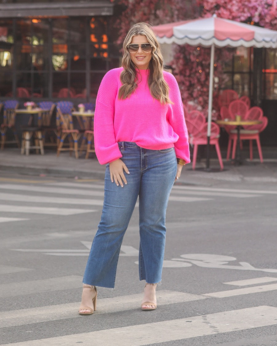 a pink long sleeve sweater with a drop-shoulder for a relaxed fit, a crew neckline, and a ribbed hemline on a textured ultra-soft design fabric