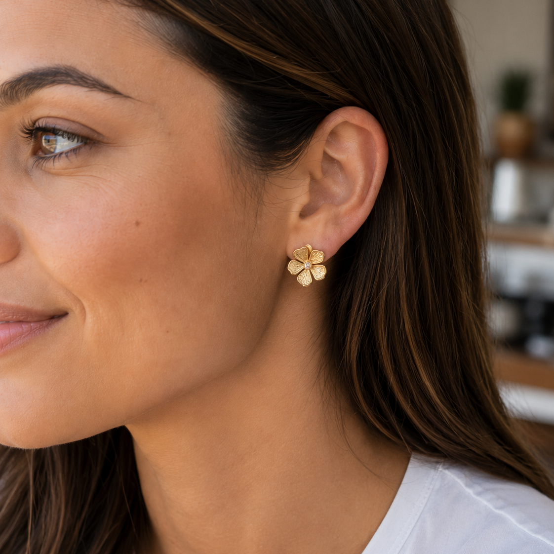gold intricately detailed flower stud-post earrings with a center stone and gold comfort earring back