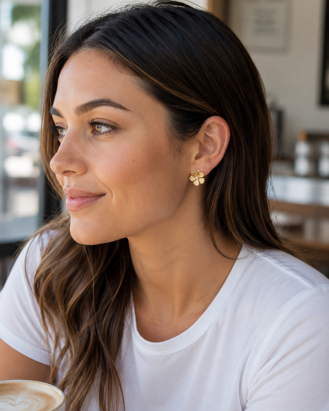 gold intricately detailed flower stud-post earrings with a center stone and gold comfort earring back