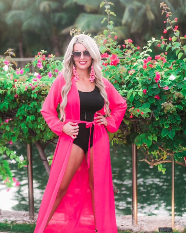 solid pink ultra long coverup made of lightweight, sheer material with an elastic wrist band and a removable tie