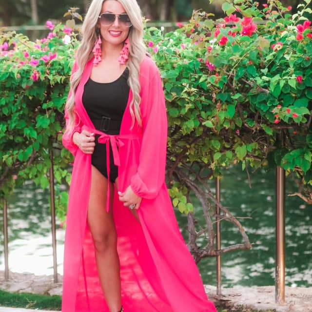 solid pink ultra long coverup made of lightweight, sheer material with an elastic wrist band and a removable tie