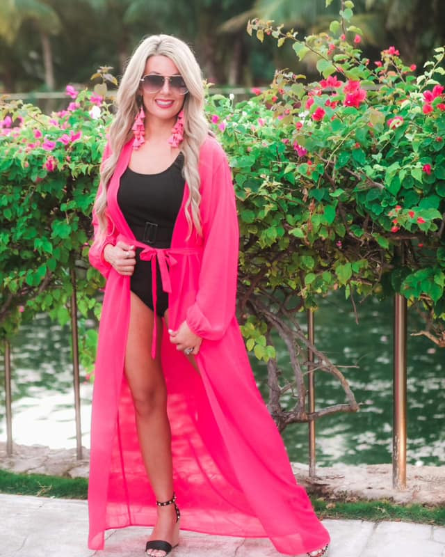 solid pink ultra long coverup made of lightweight, sheer material with an elastic wrist band and a removable tie