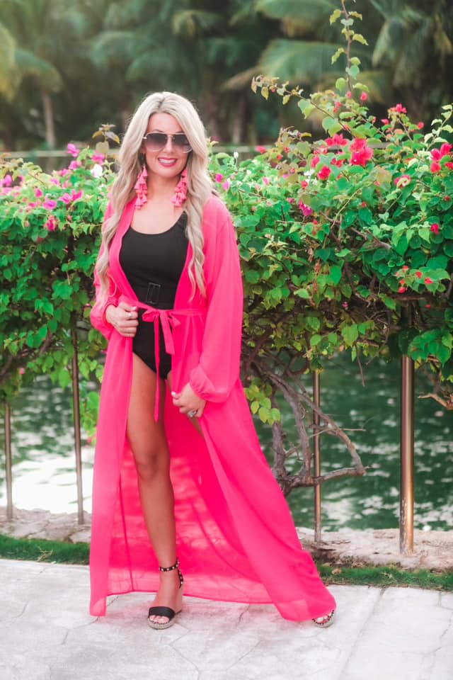 solid pink ultra long coverup made of lightweight, sheer material with an elastic wrist band and a removable tie