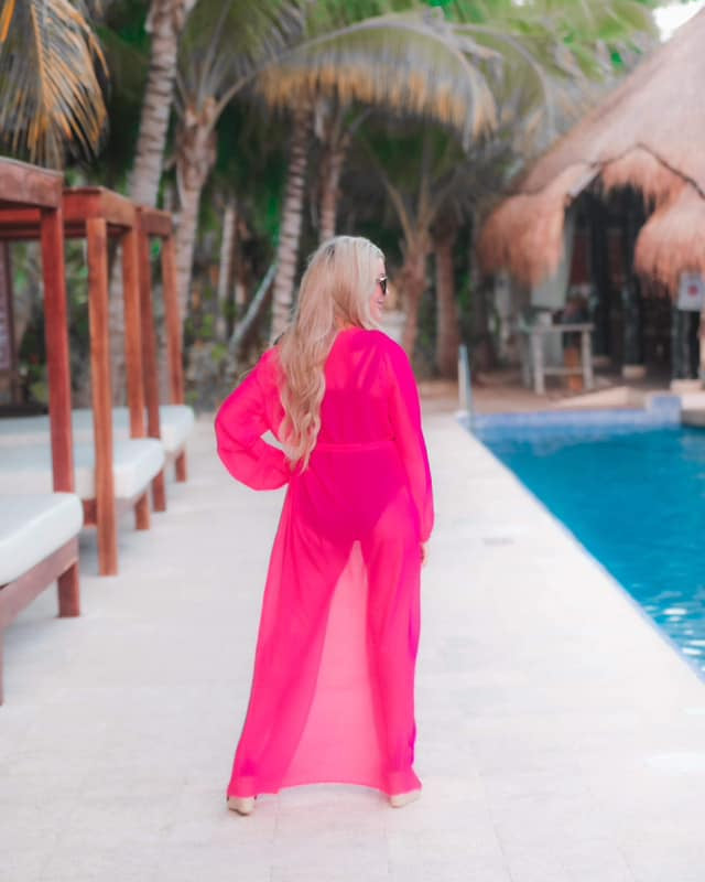 solid pink ultra long coverup made of lightweight, sheer material with an elastic wrist band and a removable tie